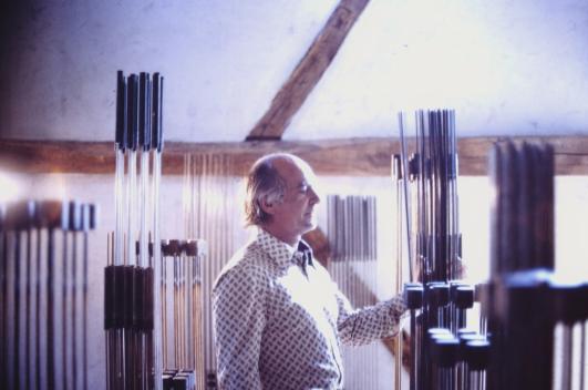 Bertoia playing sounding pieces in his barn
