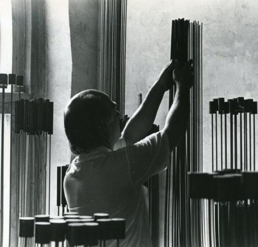 Bertoia clasping tall rods of Monel or Inconel to create a curious, harsh sound.